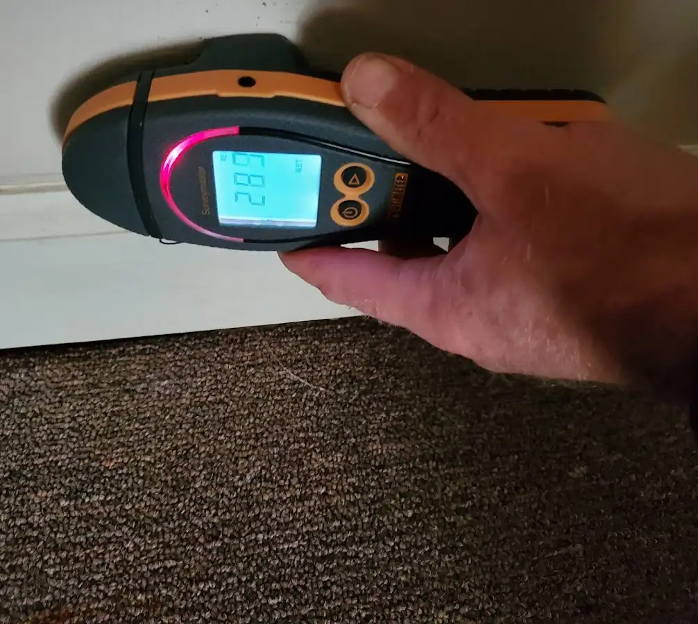 Moisture detection at baseboard during Storm Damage Restoration in Hudsonville